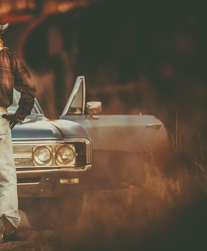 Western Wear Caucasian Men and His Classic Muscle Car. Cowboy Vintage Ride.
